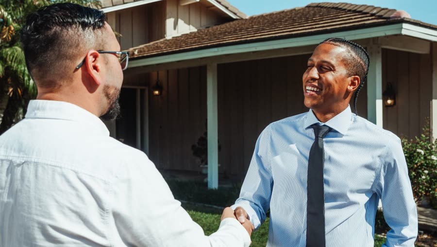 Remodeler shaking hands with a homeowner after closing a deal